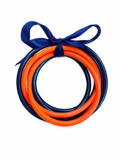 A set of five plastic lasso loops in orange, navy blue, and dark blue, tied together with a matching navy ribbon bow on a white background.